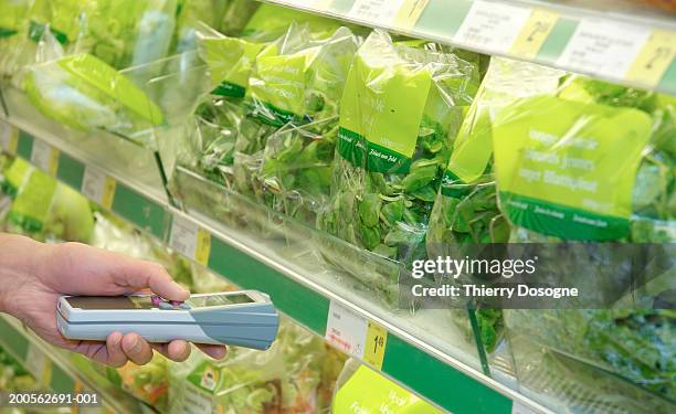 man using barcode reader in supermarket, close-up - groceries bag stock pictures, royalty-free photos & images