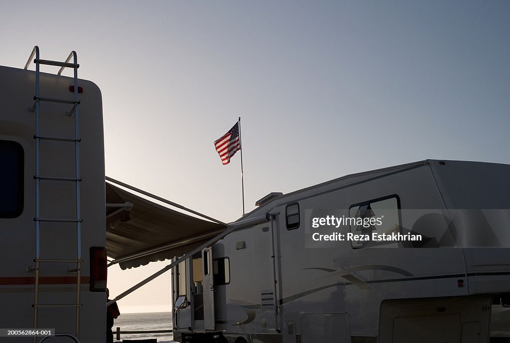 Mature man standing by motor home