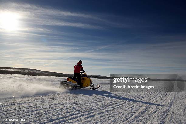 person on snowmobile - snowmobile stock pictures, royalty-free photos & images