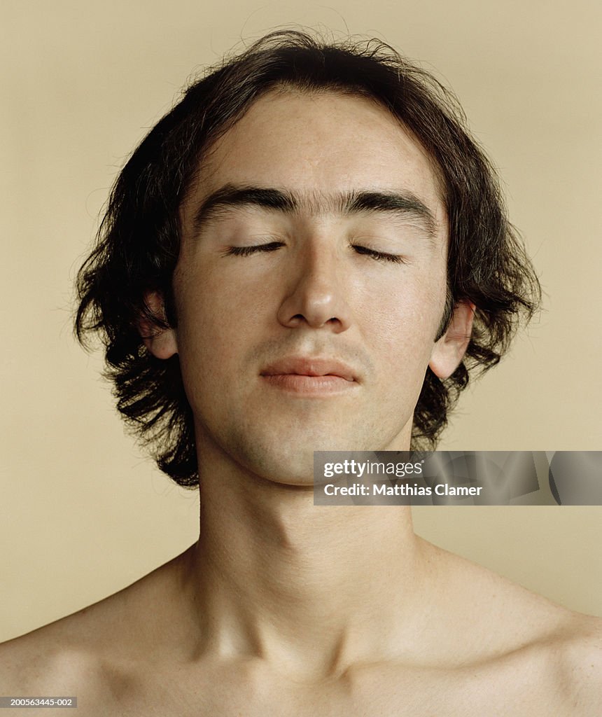 Young man of hispanic descent with eyes closed, close-up