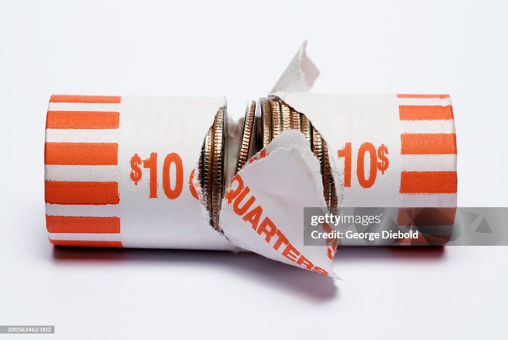 Broken roll of quarter coins on white background