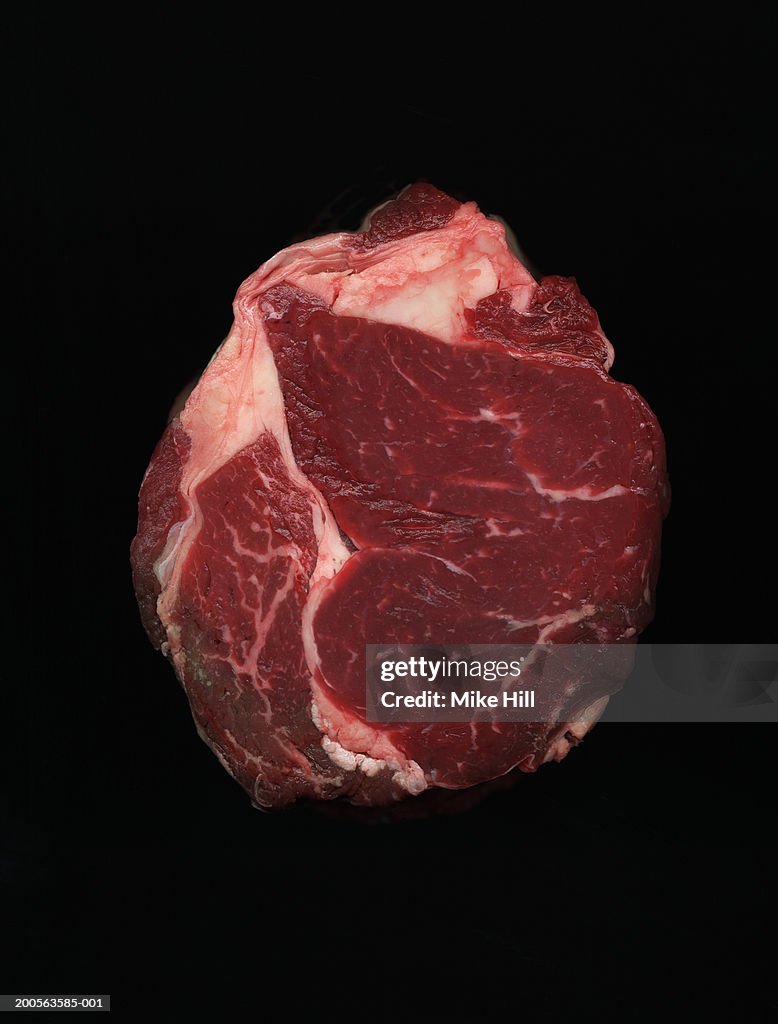 Joint of beef against black background, close-up