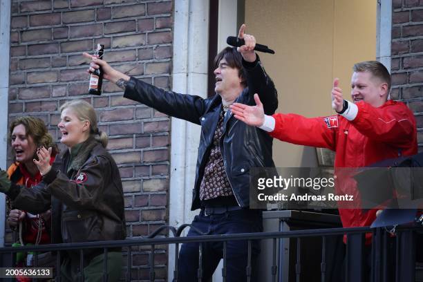 Singer Campino of the German band Die Toten Hosen performs from a balcony during the annual Rose Monday Carnival parade on February 12, 2024 in...