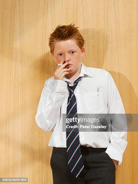 boy (10-11) wearing shirt and tie, smoking cigarette, portrait - boys smoking cigarettes stock pictures, royalty-free photos & images