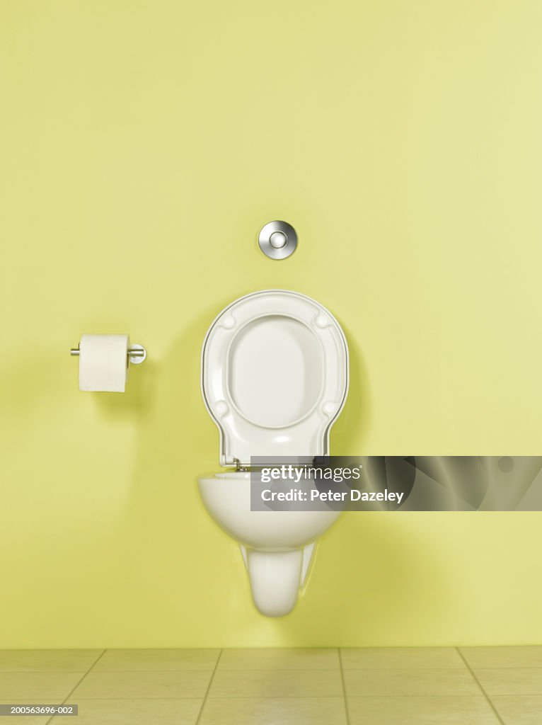 Toilet in yellow room, front view