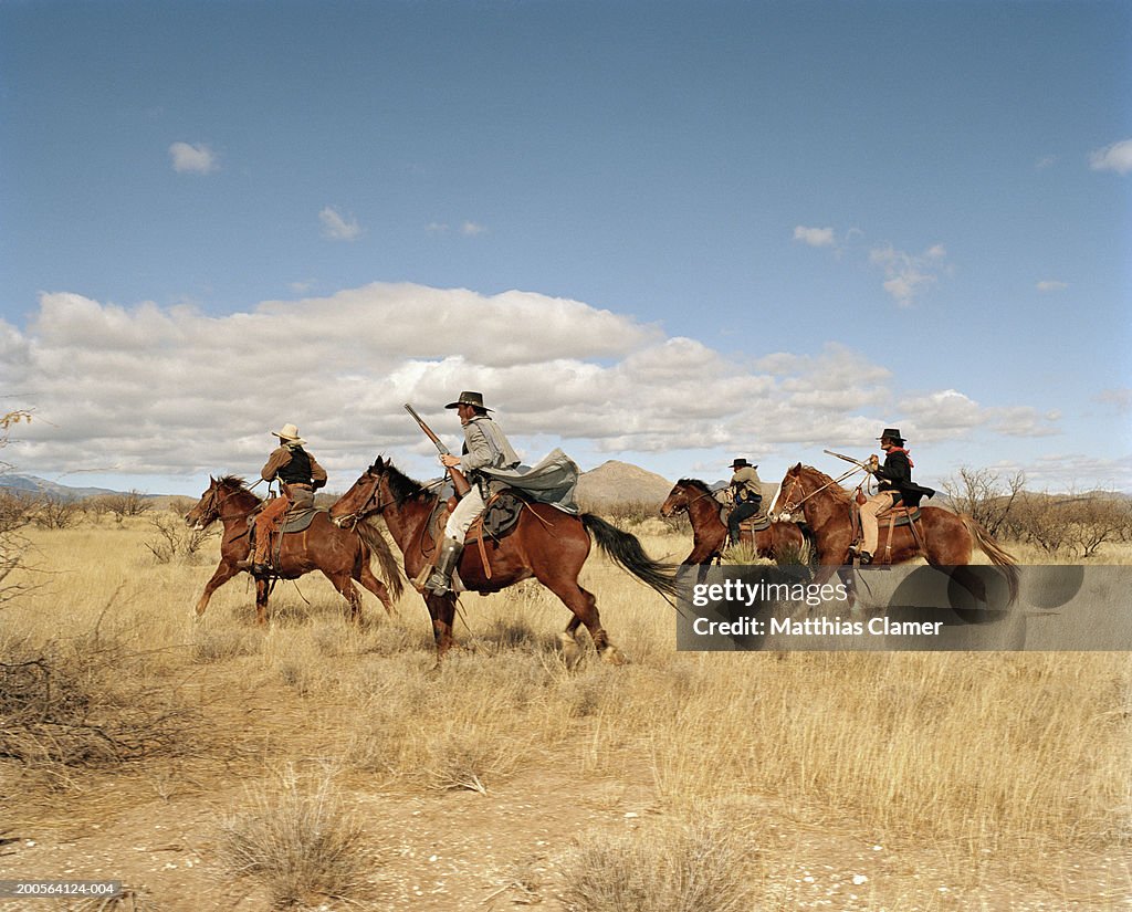 Cowboys riding on horses