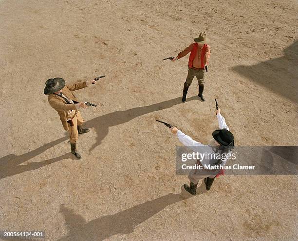 cowboys having gun duel in old west town - vingança imagens e fotografias de stock