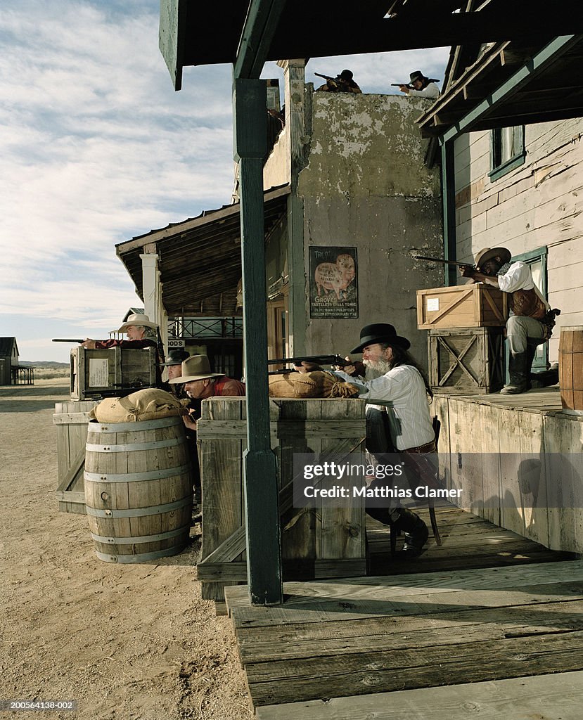 Cowboys with guns in old west town