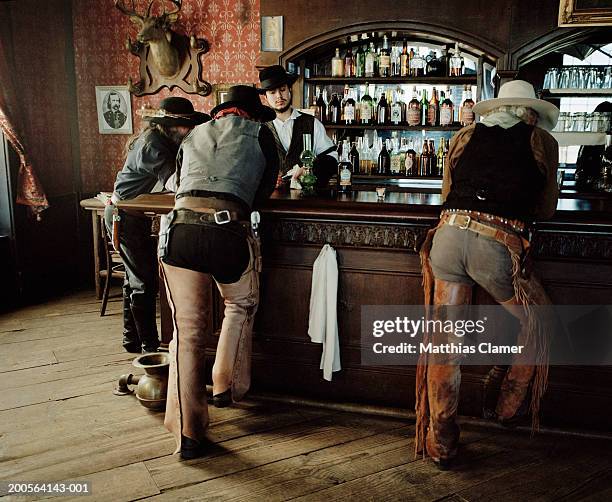 cowboys at saloon - western saloon photos et images de collection