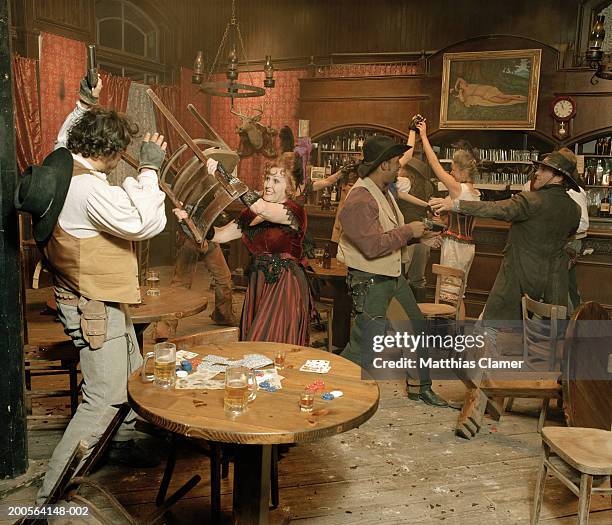 cowboys fighting in saloon - western saloon photos et images de collection