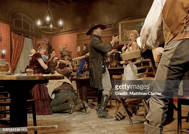 cowboys fighting in saloon - saloon photos et images de collection