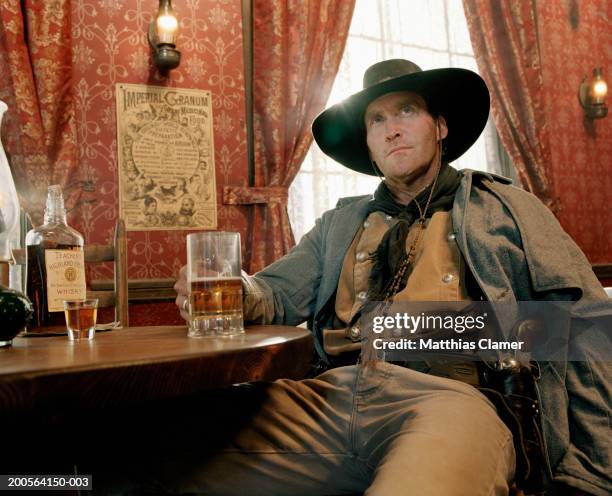 cowboy drinking beer at saloon - western saloon photos et images de collection