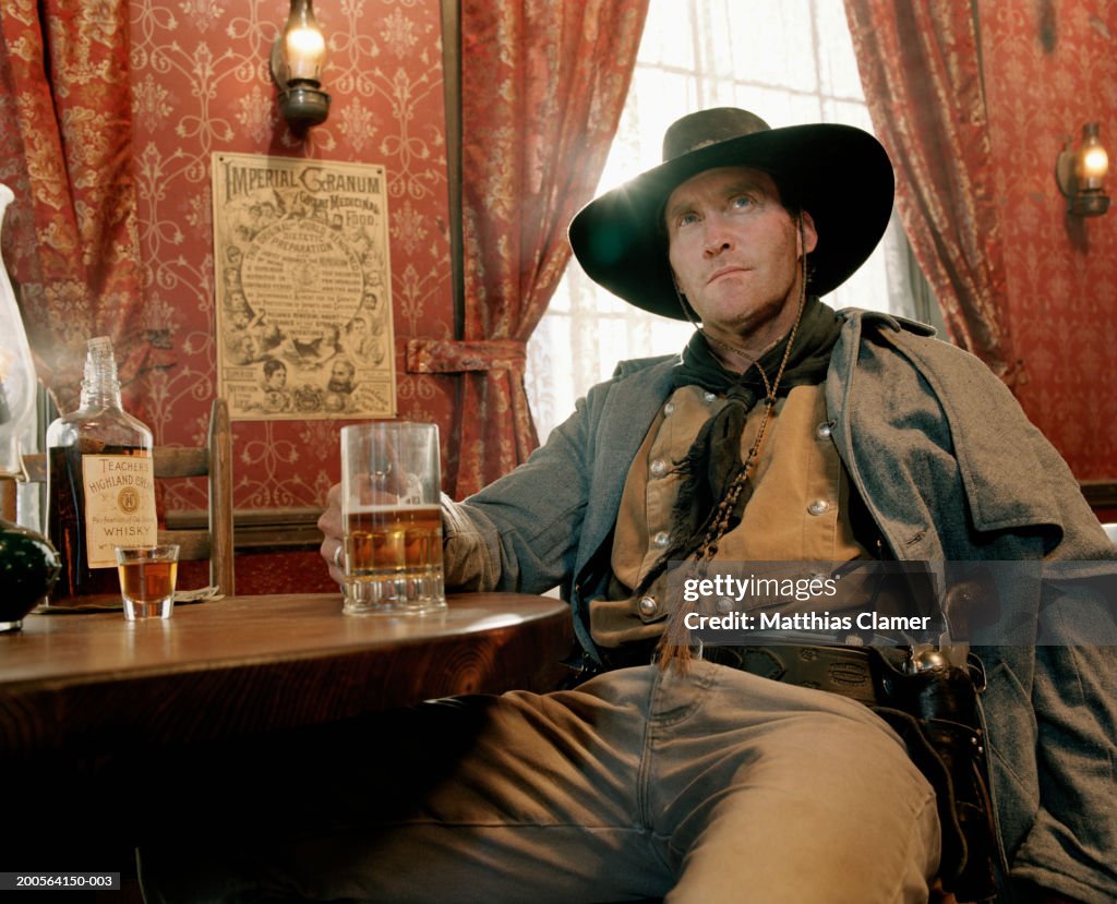 Cowboy drinking beer at saloon