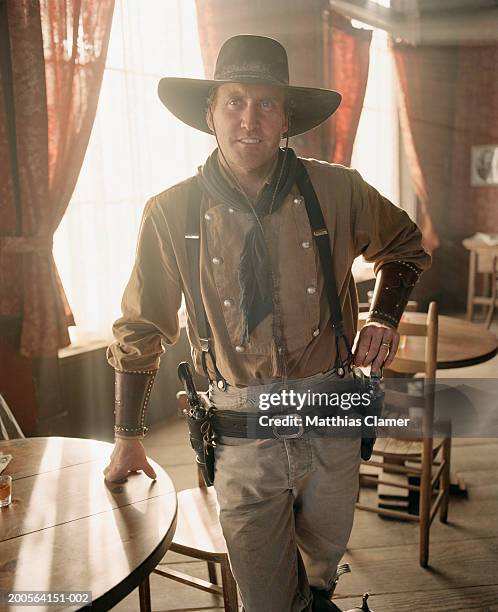 cowboy at saloon, portrait - saloon photos et images de collection