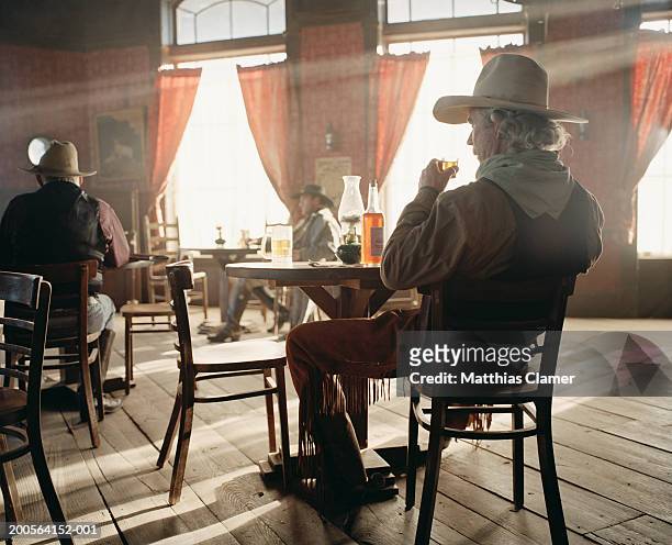 cowboy drinking beer at saloon - saloon bildbanksfoton och bilder