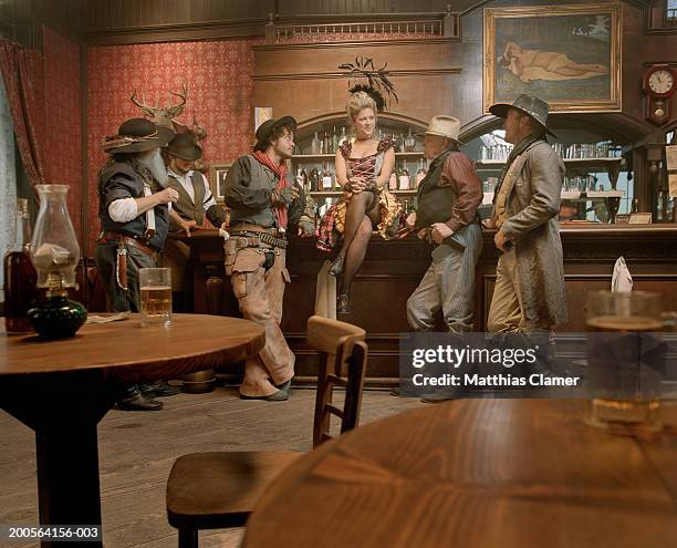 cowboys flirting with showgirl in saloon - western saloon photos et images de collection