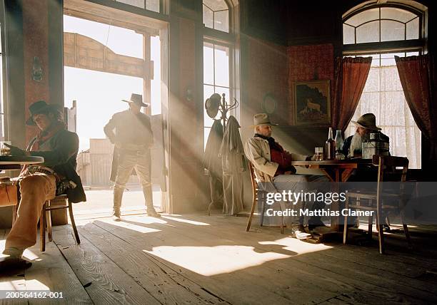 cowboys at saloon - western saloon photos et images de collection