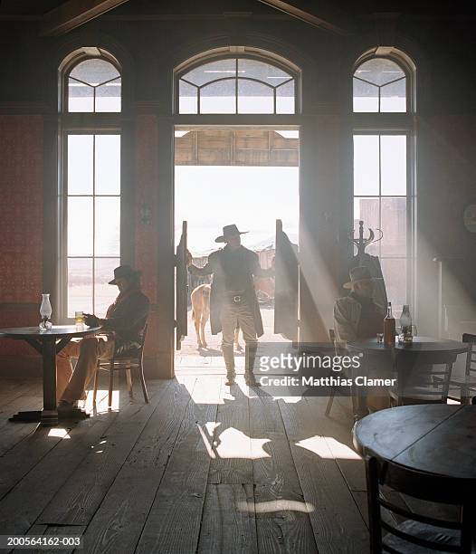 cowboys at saloon - saloon photos et images de collection