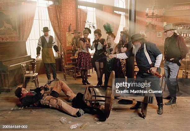 cowboys fighting in saloon - saloon photos et images de collection