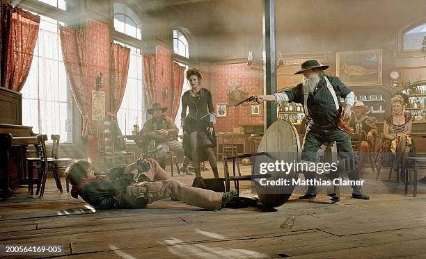 cowboys fighting in saloon - western saloon photos et images de collection