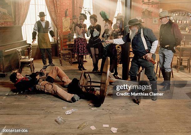 cowboys fighting in saloon - saloon photos et images de collection