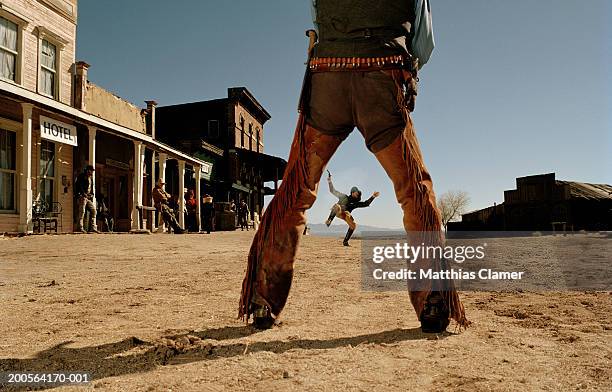 cowboys having gun duel in old west town - 拓荒前的美國西部 個照片及圖片檔