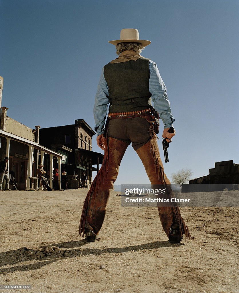 Cowboys having gun duel in old west town