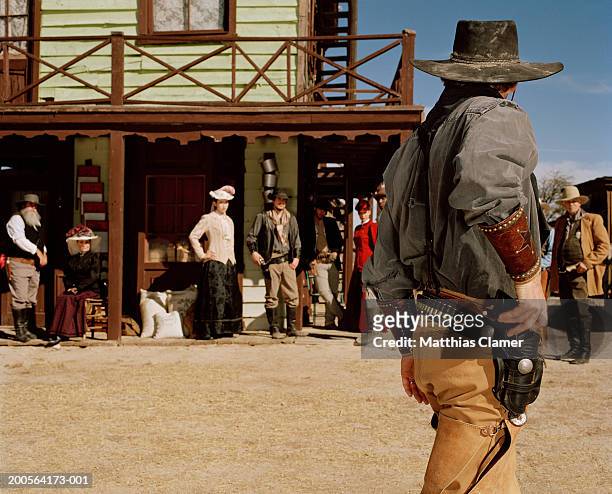 cowboy with gun in old west town - old west town stock pictures, royalty-free photos & images