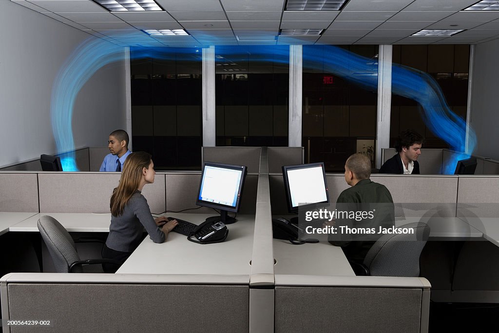 Businesspeople in office,computers connected with stream of blue light