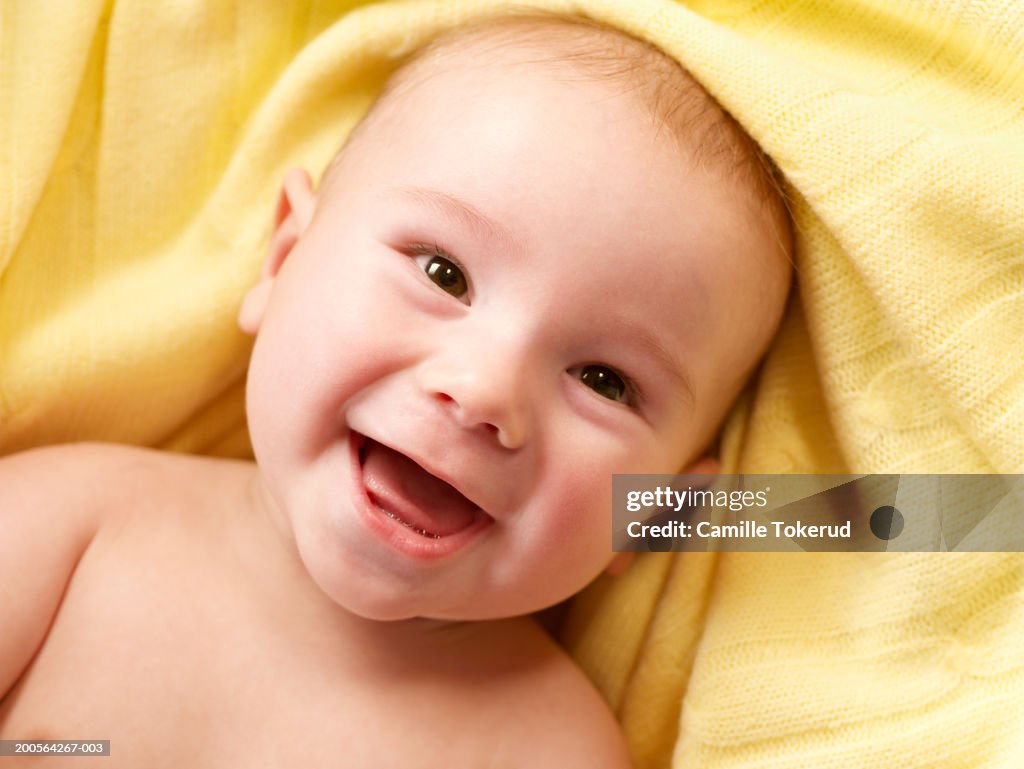 Baby boy (3-6 months) laughing, elevated view, close-up