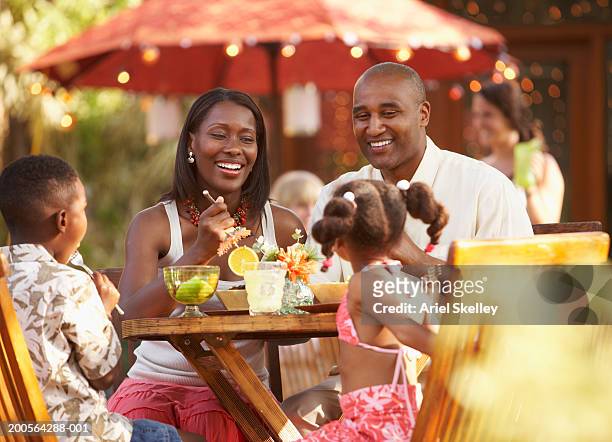 family dining in restaurant - black couple dining stockfoto's en -beelden