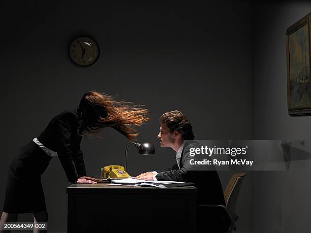 male and female office workers, wind blowing woman's hair over face - ominous stock-fotos und bilder