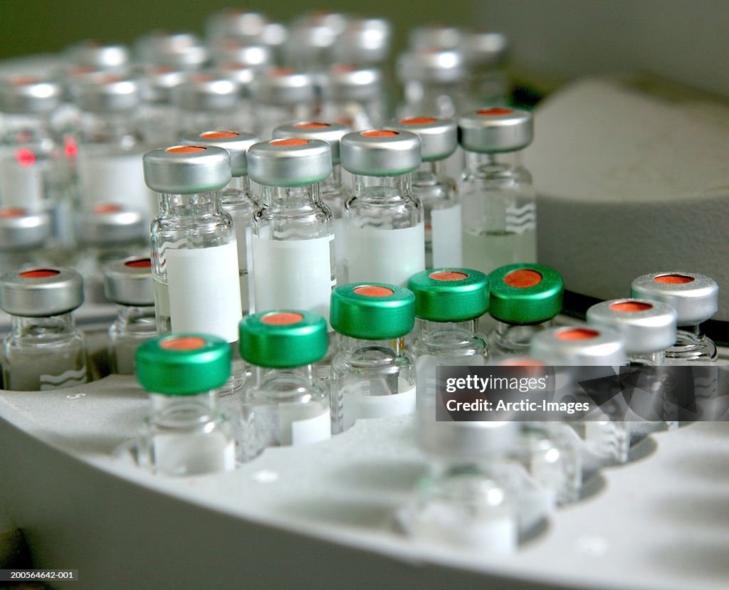 Small medical bottles in centrifuge, close-up