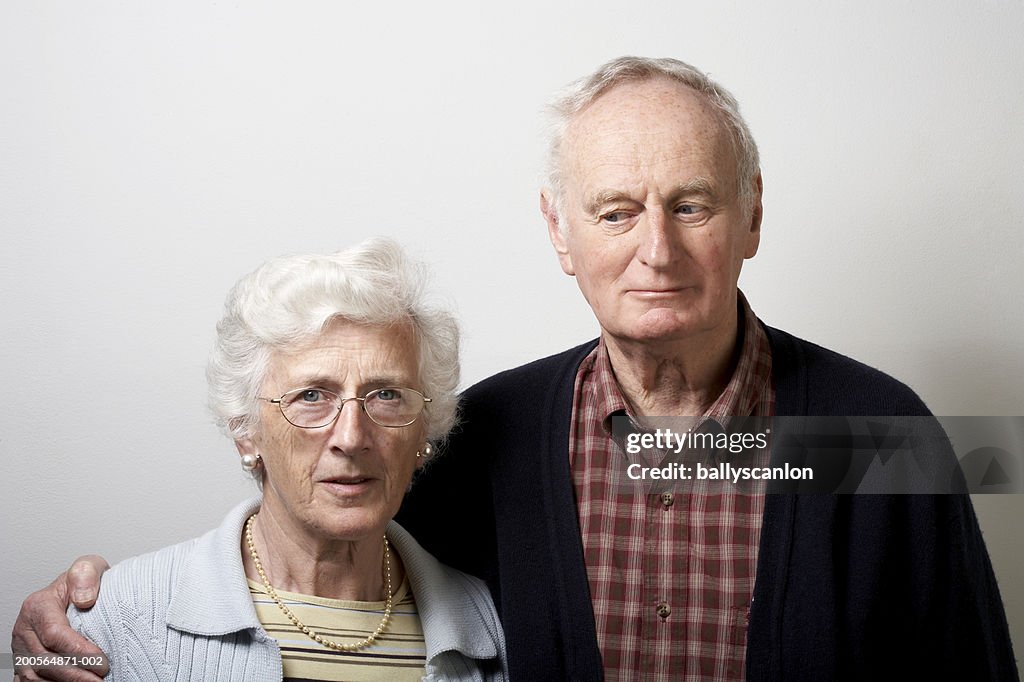 Senior man with arm around senior woman, portrait