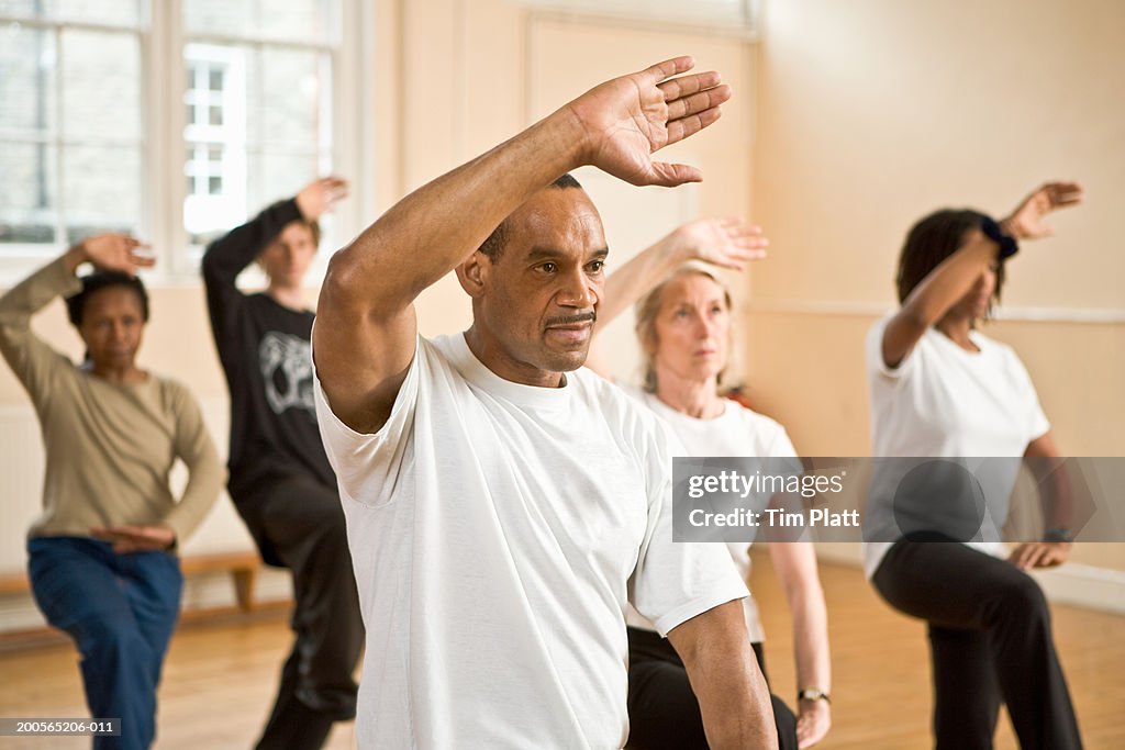 Group of people practicing posture during Tai Chi class