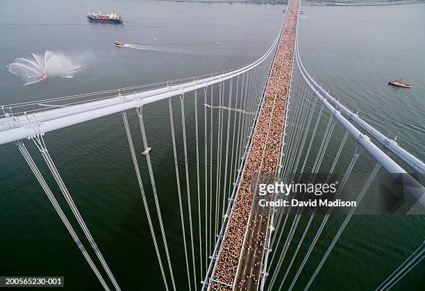 new york city marathon runners crossing verrazano bridge, aerial view - marathon stock-fotos und bilder