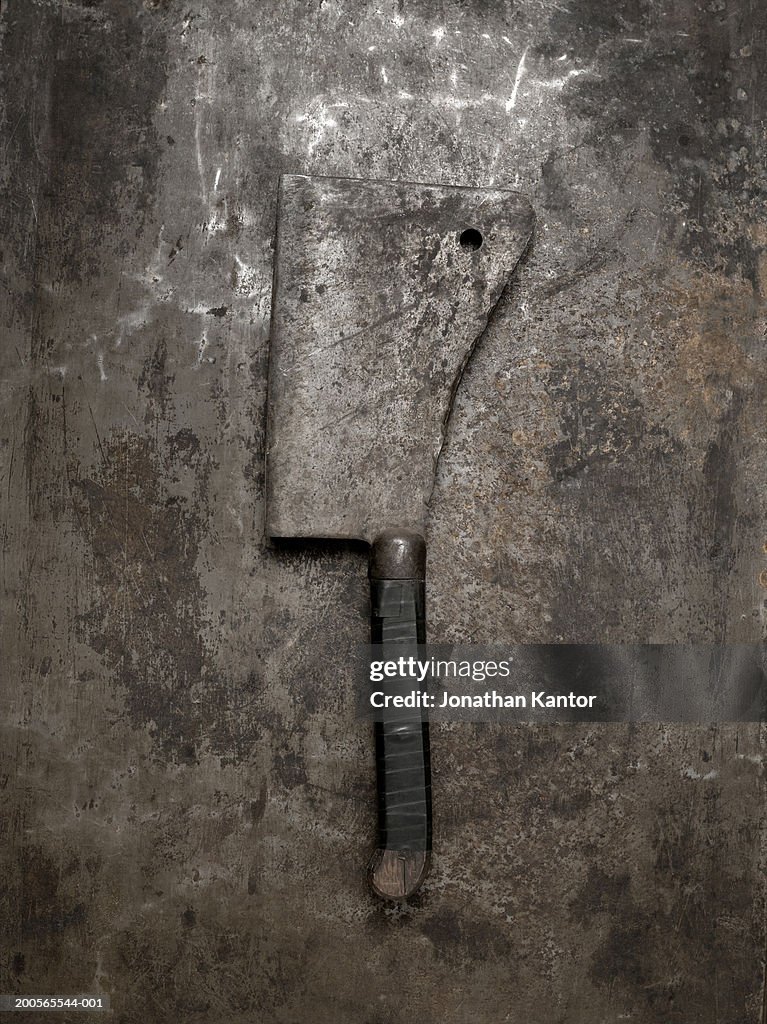 Meat cleaver on metal background, overhead view