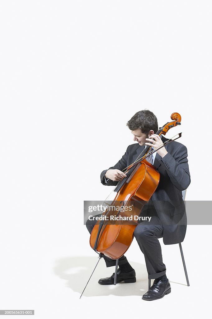 Businessman tuning cello