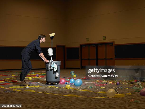 man pushing dustbin in auditorium - leftover stock pictures, royalty-free photos & images