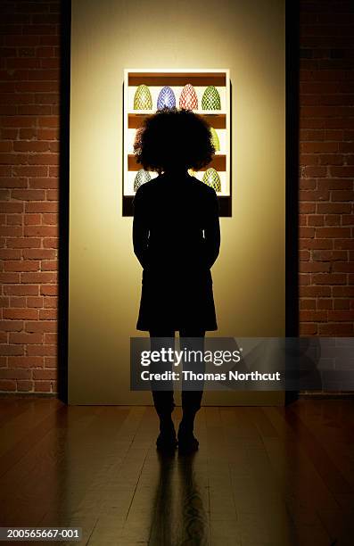 silhouette of girl (10-11) standing at doorway - curls girl silhouette stock pictures, royalty-free photos & images