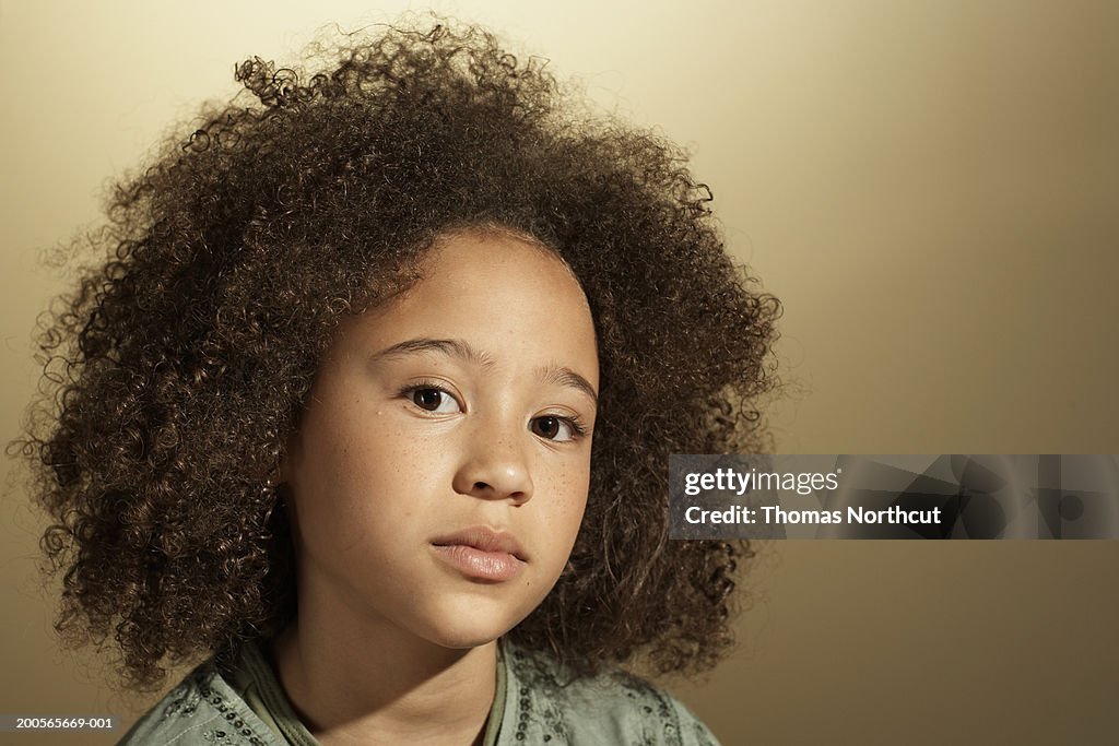 Girl (10-11) with curly hair, close-up, portrait
