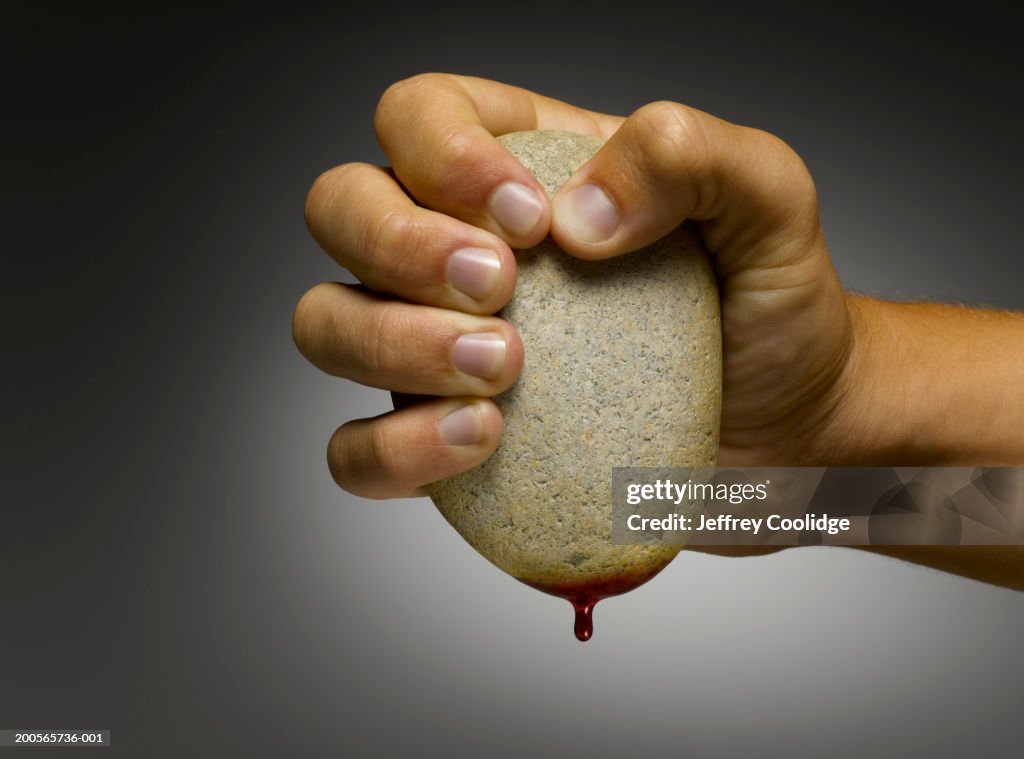 Man squeezing blood from stone