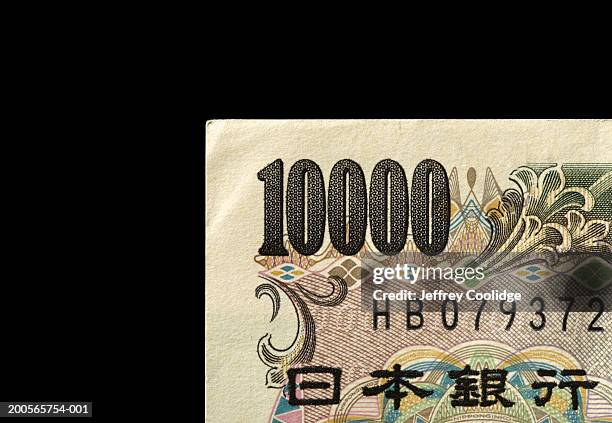 ten thousand yen note against black background, close-up - ten thousand yen note stock-fotos und bilder