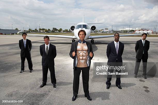 five businessmen standing by plane on runway, portrait - 5 funny foto e immagini stock