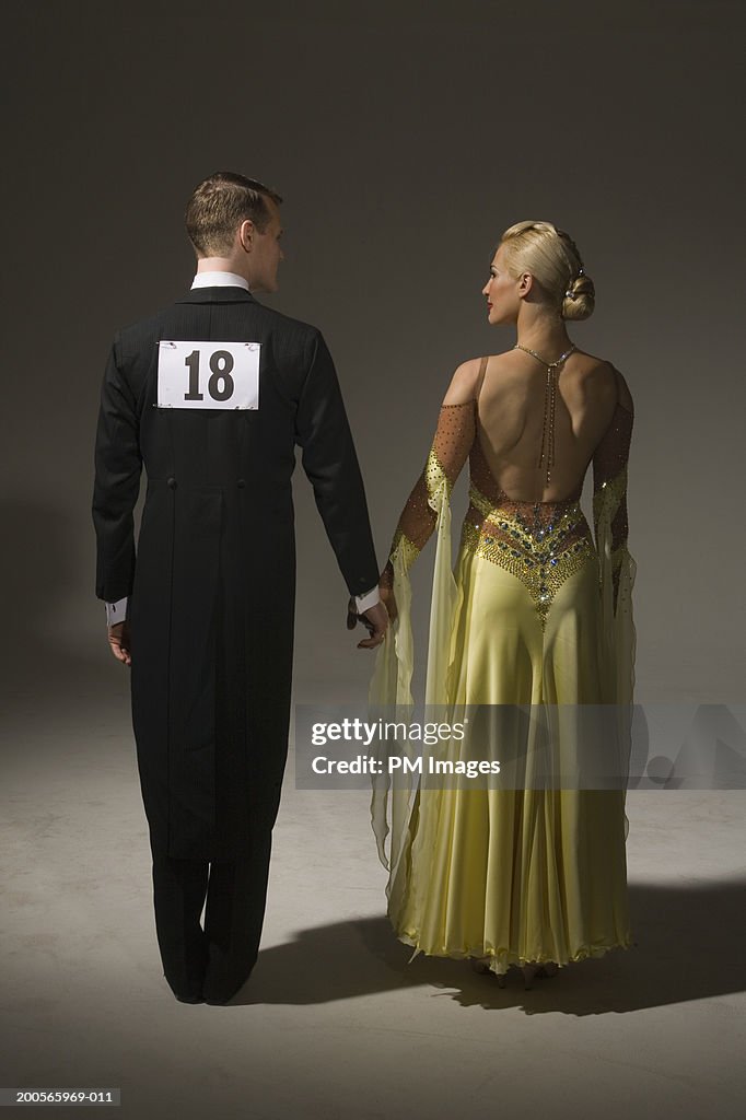 Competitive ballroom dancing pair, rear view