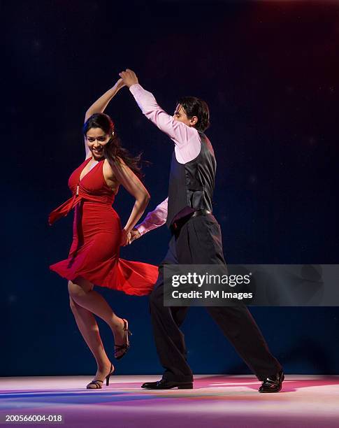 young couple swing dancing indoors - swing dance stock pictures, royalty-free photos & images