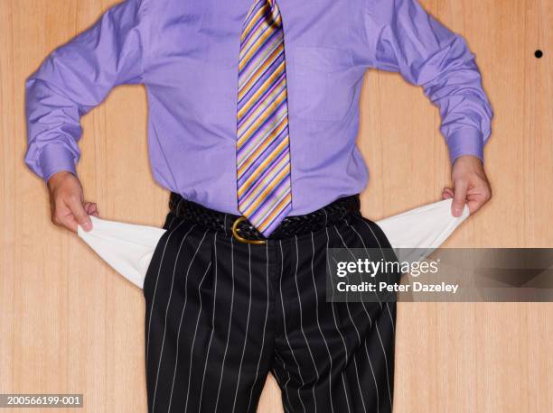 man with empty pockets , mid section - hosentasche stock-fotos und bilder
