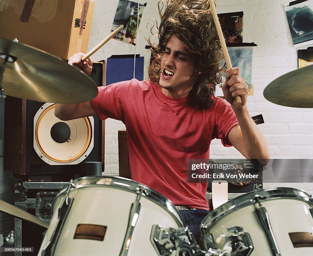 Young man playing drums, front view