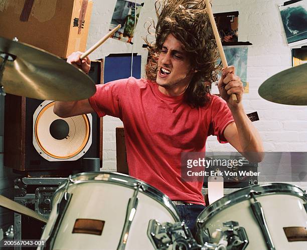 young man playing drums, front view - musician stock pictures, royalty-free photos & images