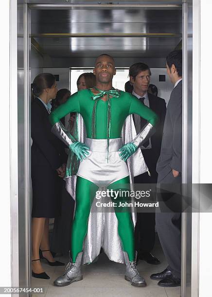 man in superhero costume in elevator - superhero costume stock pictures, royalty-free photos & images